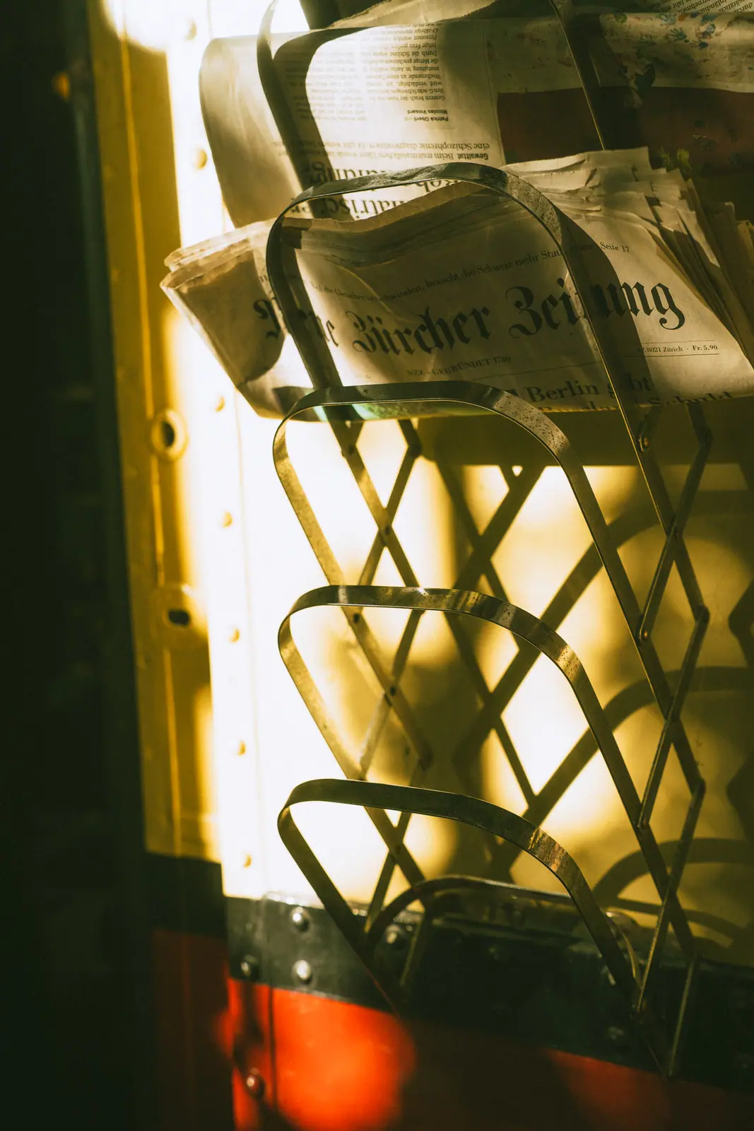 Brand photography Zürich — newspaper rack detail in warm afternoon light